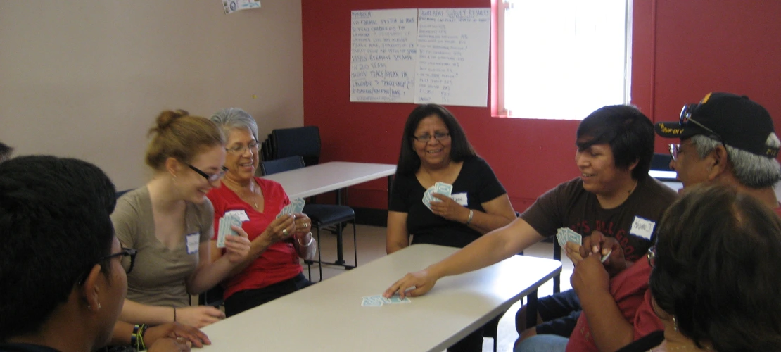 people playing cards around the table